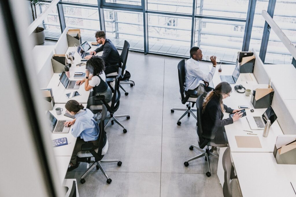 group of employees working at desk from a top-down view