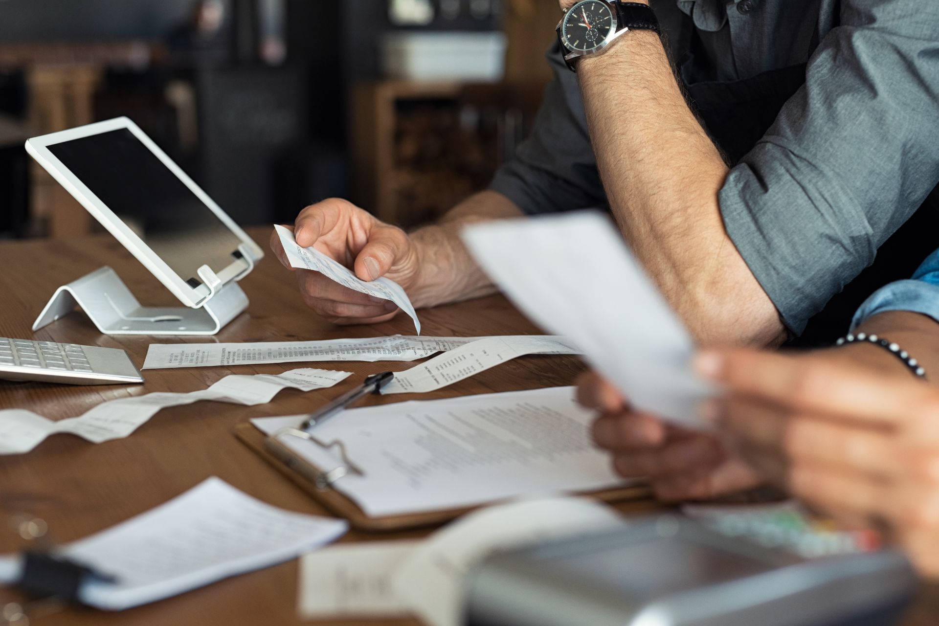 Business owner reviewing increasing coworking invoices and expenses