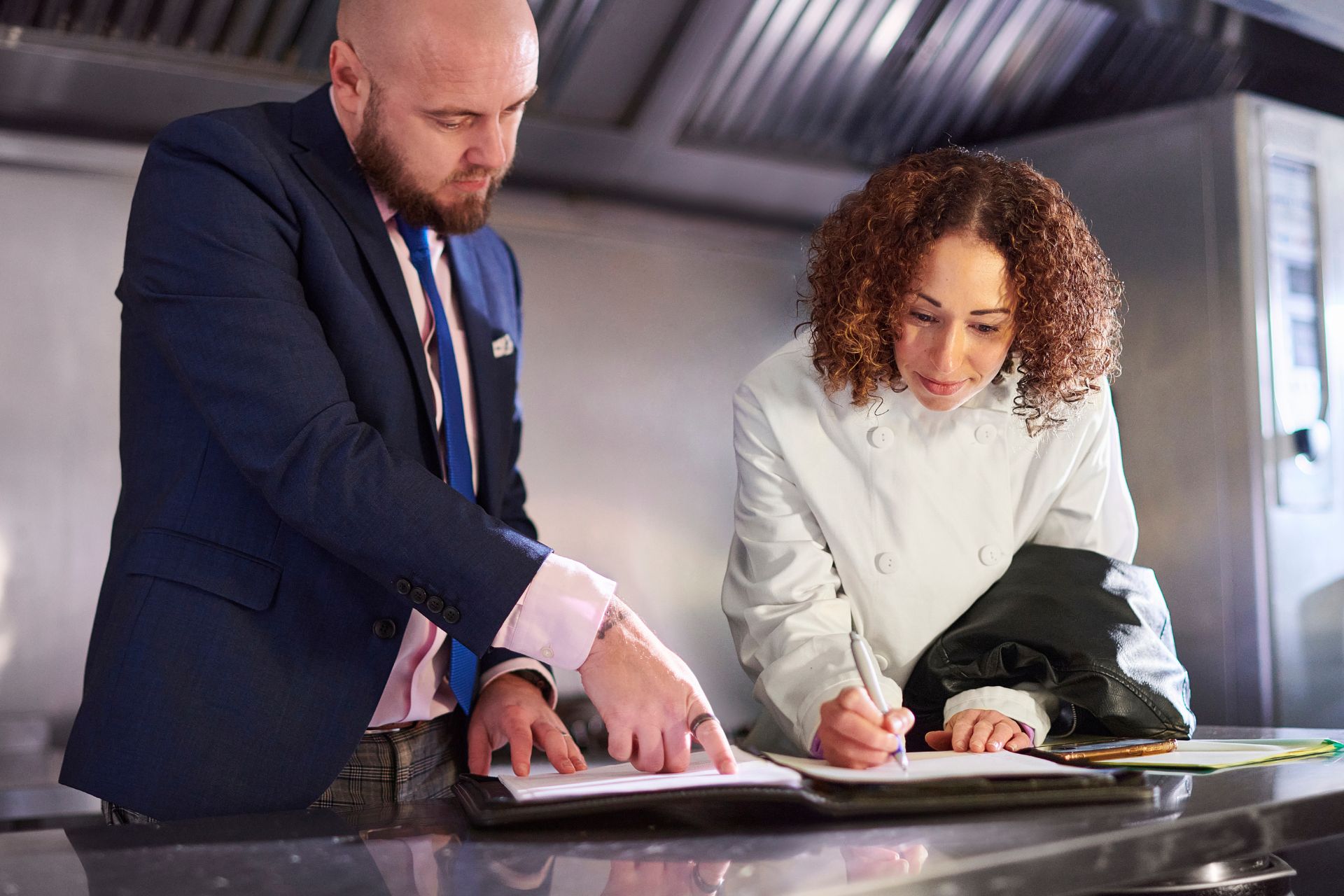 A business owner signs documents to finalise a new office lease