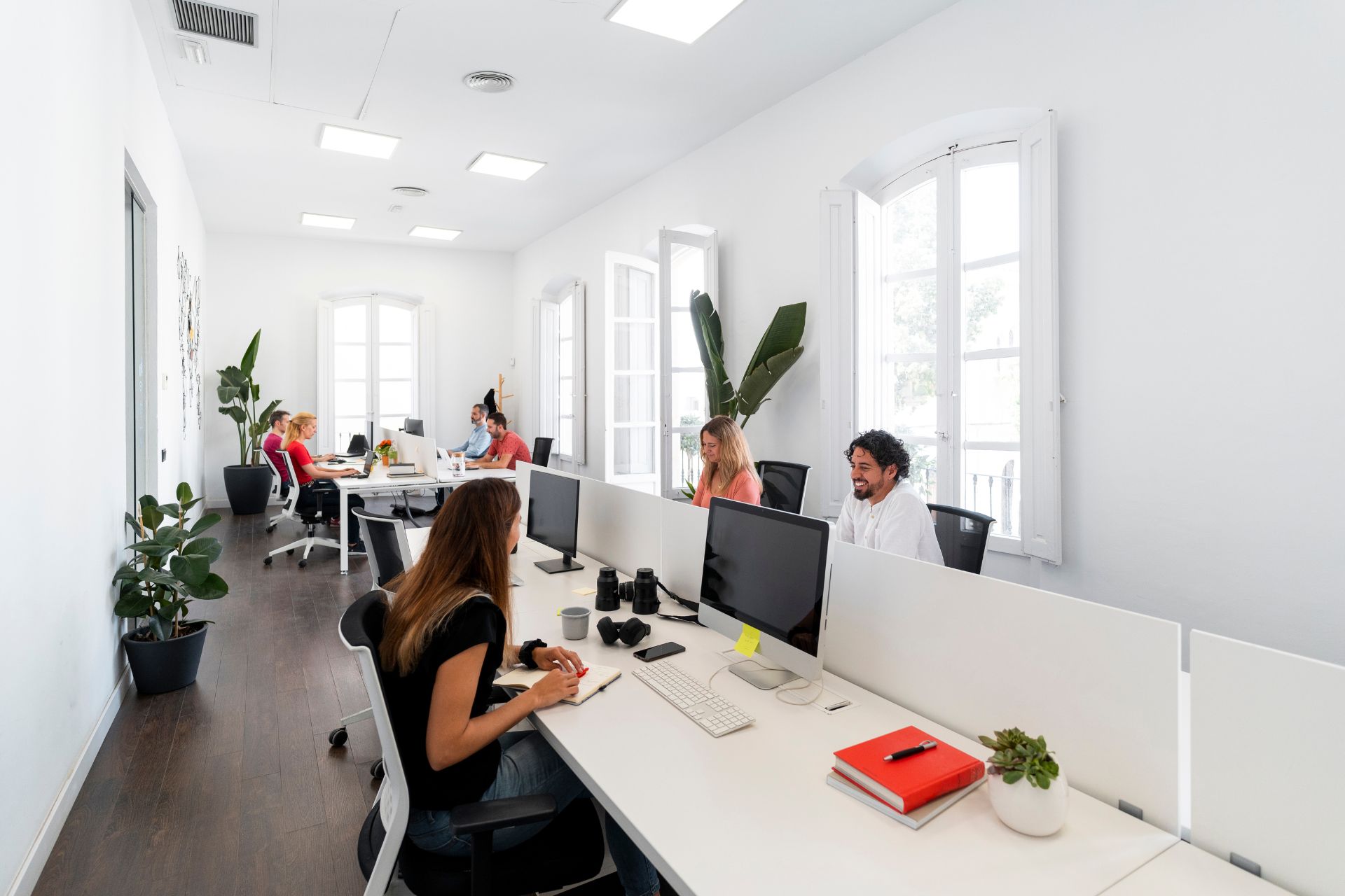 Coworkers working on computers in modern open space office