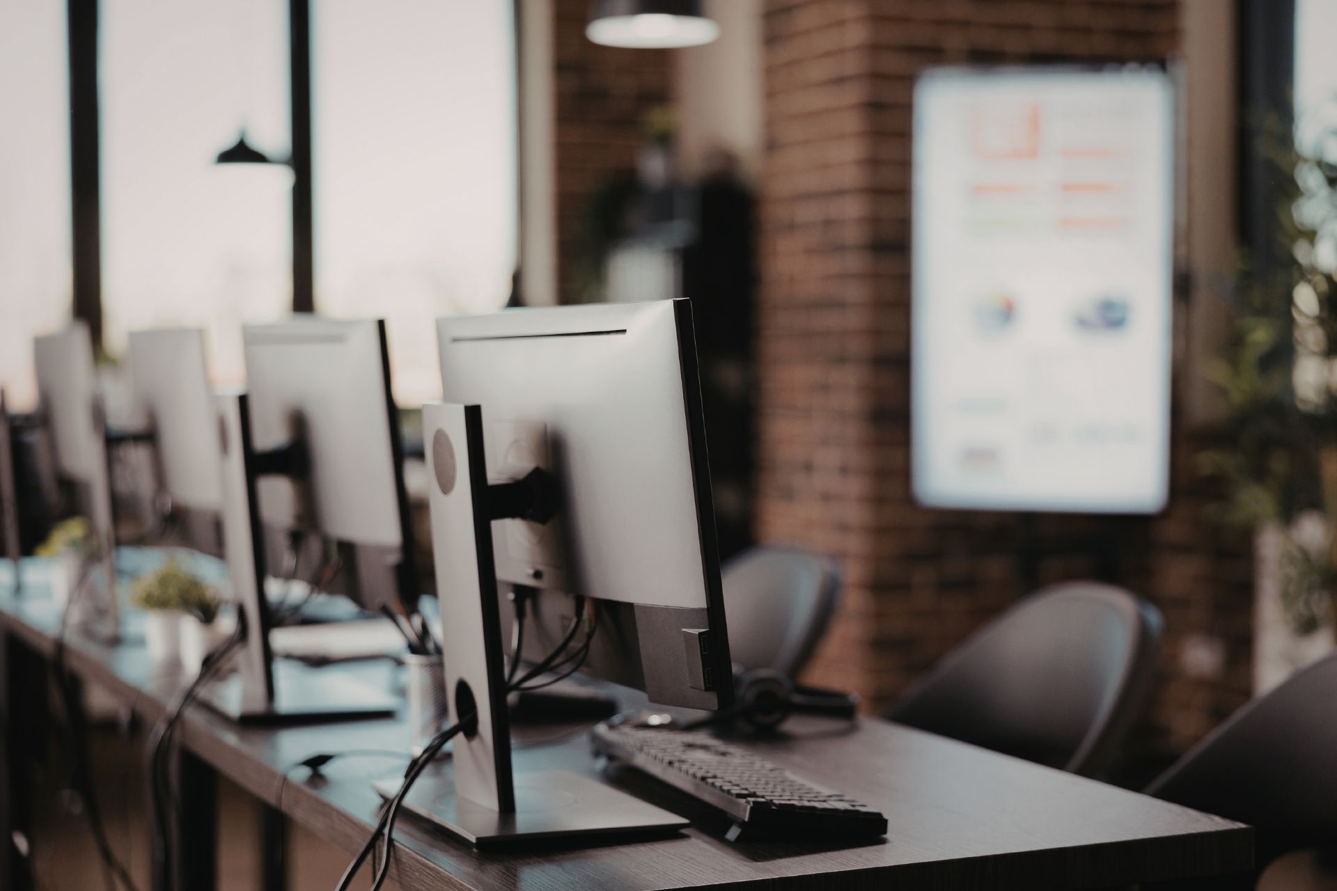Modern office workstations with computers and chairs