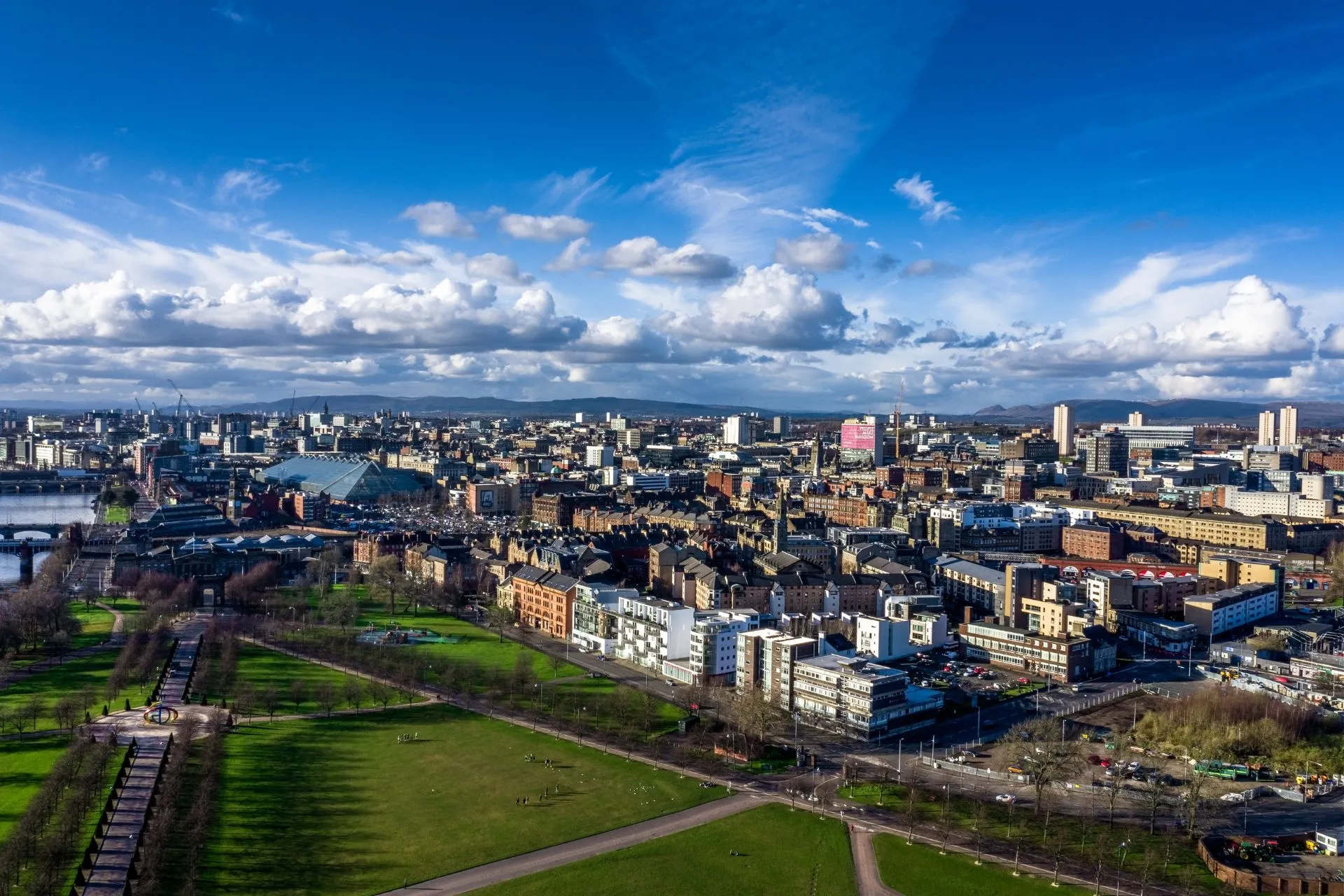 Aerial view over Glasgow rooftops and parkland