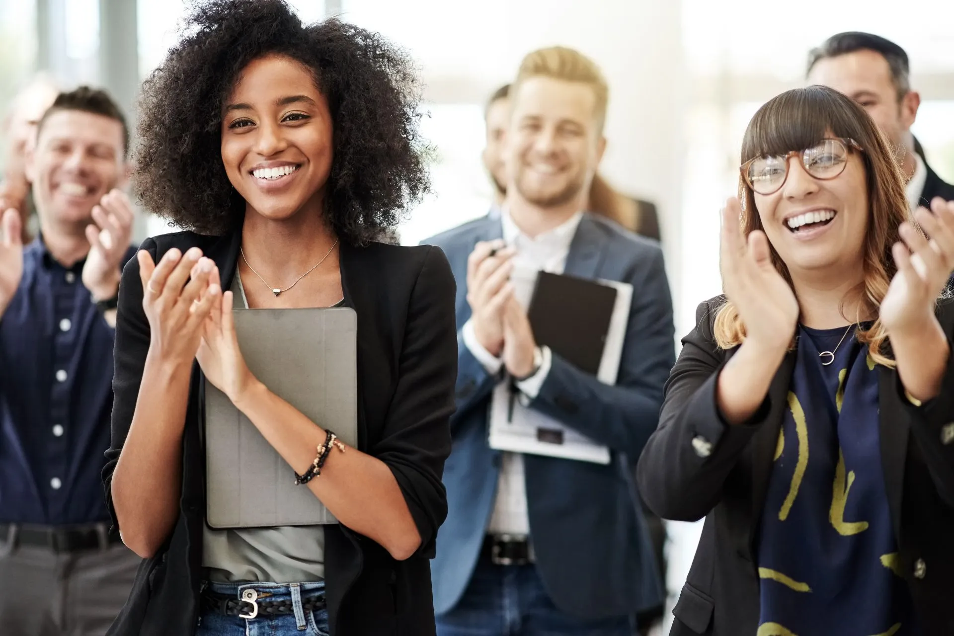Office employees applauding a colleague