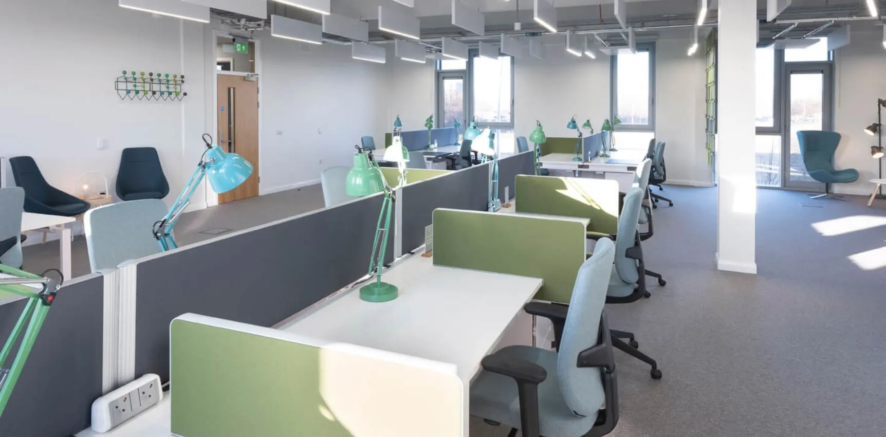 Serviced office at RedTree with white desks and green desk screens