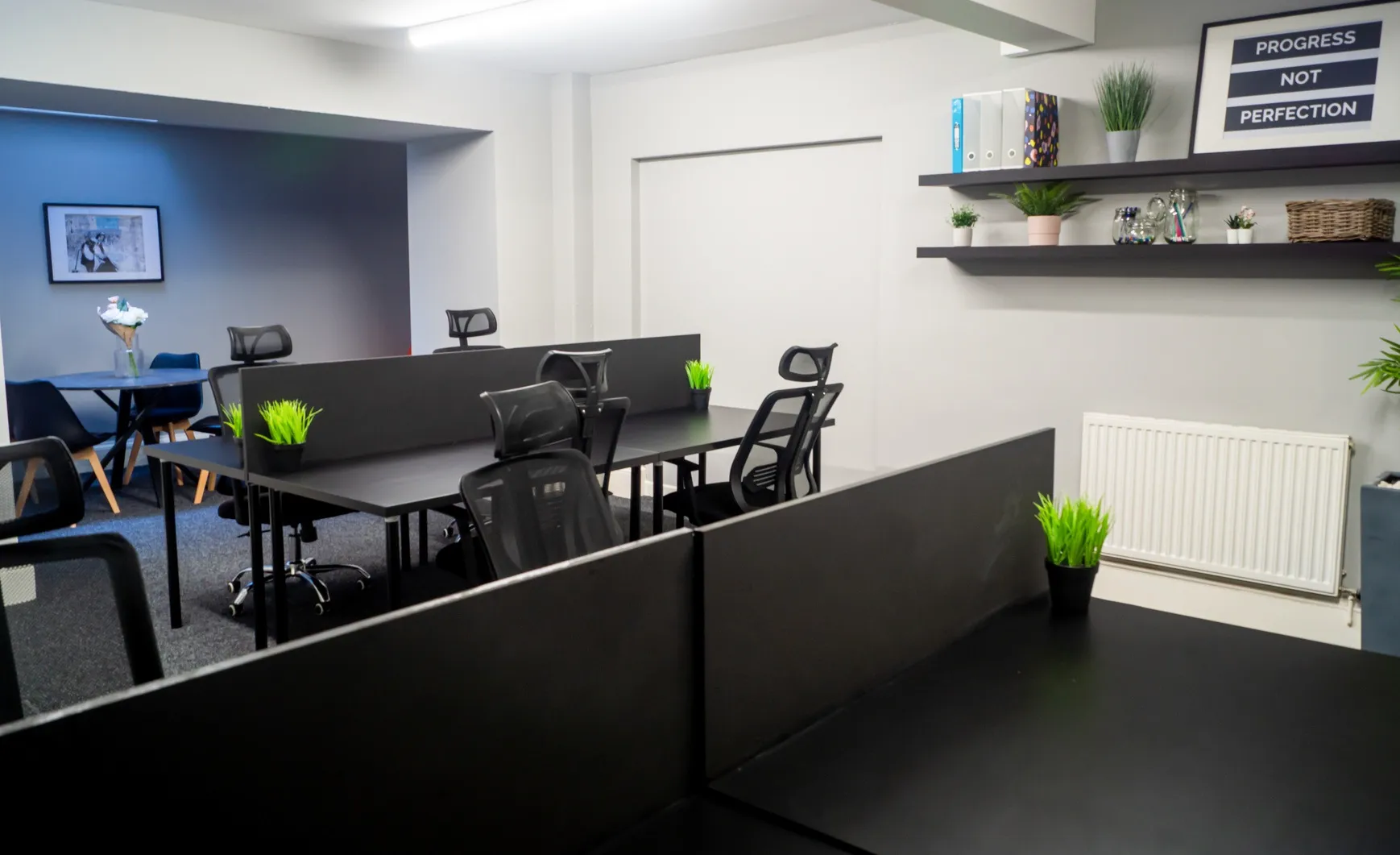 Suite 2 at The Townhouse with desks, shelving and framed wall art