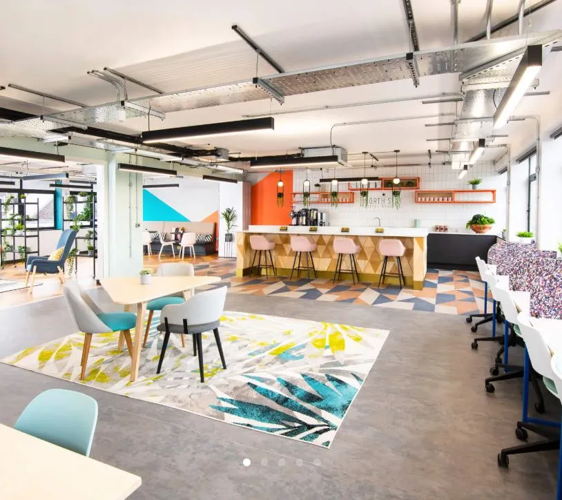 Coworking space at Wizu Workspace with a coffee bar and breakout seating