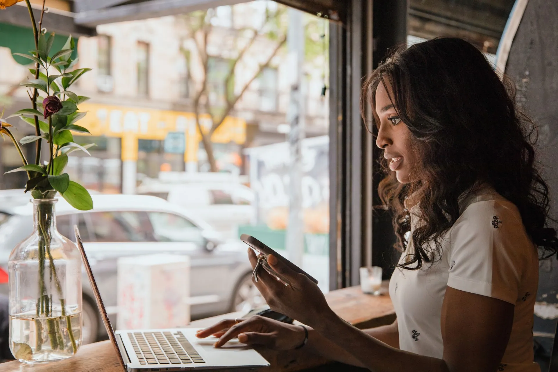 Woman using a laptop inside a café with technology-friendly amenities