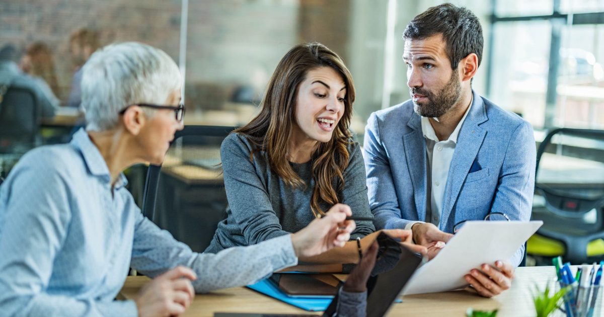 Couple going through lease agreement with their agent in the office