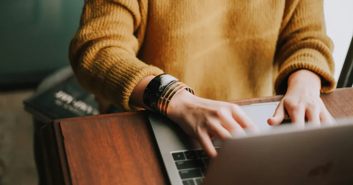 person typing on laptop